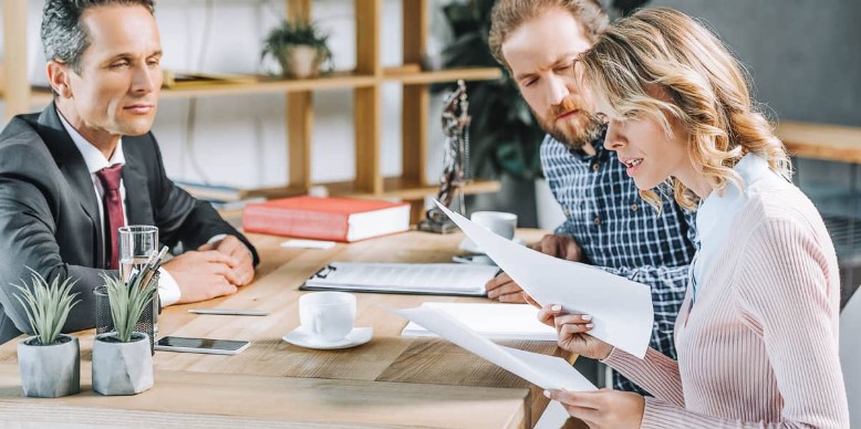 a couple reading an agreement contract