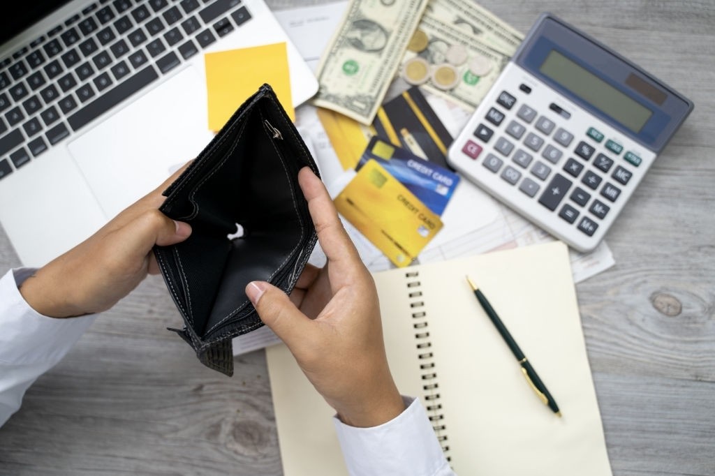 a person holding an empty wallet